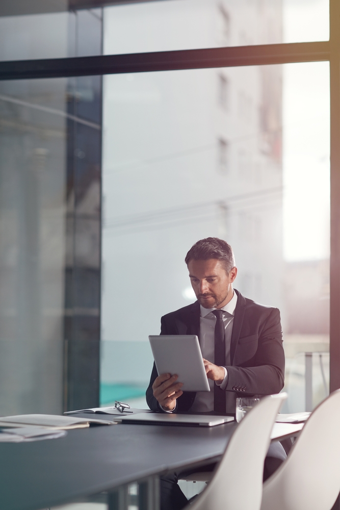 Man searching tablet at office