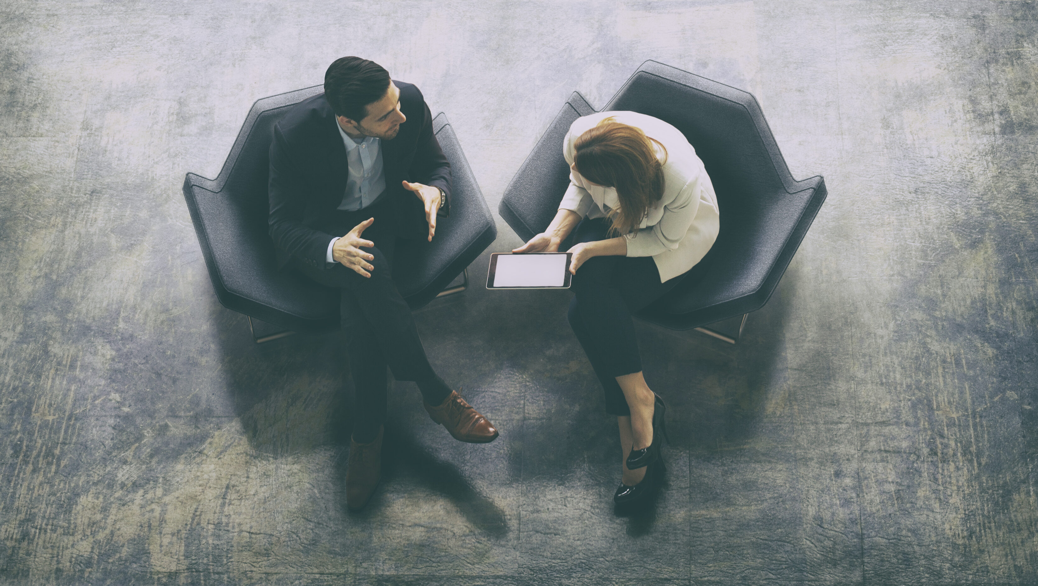 Overhead view of two business persons in the lobby
